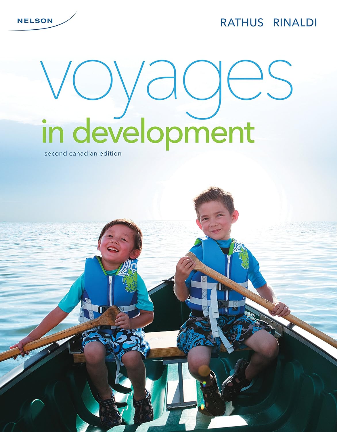 Cover of the book 'Voyages in Development, 2nd Canadian Edition' featuring two young children smiling and rowing a boat.